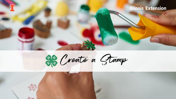 hands holding a carved stamp and rolling green ink on it